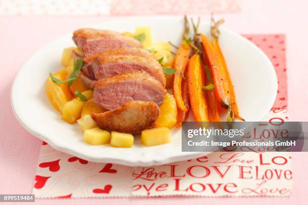 duck breast with pineapple, oranges and baby carrots - citrics stock pictures, royalty-free photos & images