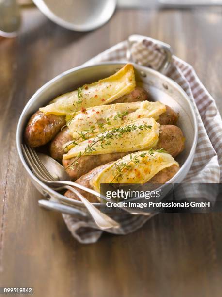 andouillettes de troyes grilled with brie de meaux - charcuterie fromage stock pictures, royalty-free photos & images