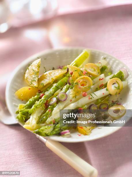 green and white asparagus with confit citrus and green olives - asparagus fern stock pictures, royalty-free photos & images