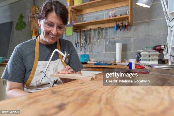 jewellery maker, making jewellery in workshop - laubsäge stock-fotos und bilder