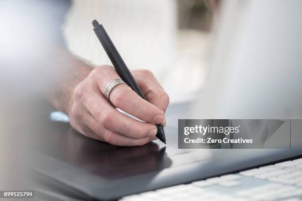cropped view of man writing with digital pen - digitized pen stock pictures, royalty-free photos & images