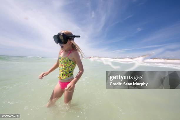 girl with swim goggles wading in sea - destin stock pictures, royalty-free photos & images