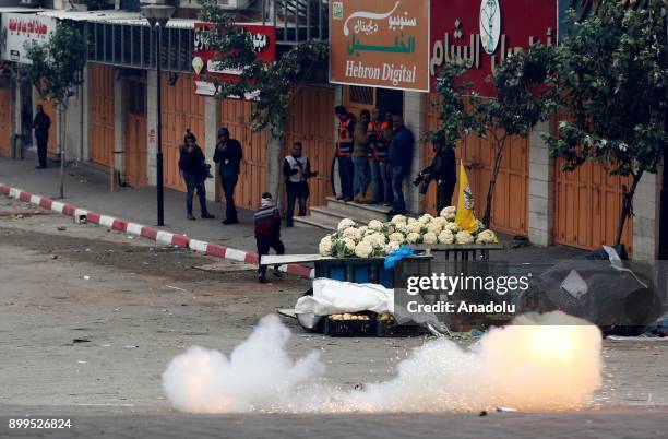 Israeli security forces use stun grenade to disperse Palestinian protestors as they protest against the U.S. President Donald Trumps recognition of...