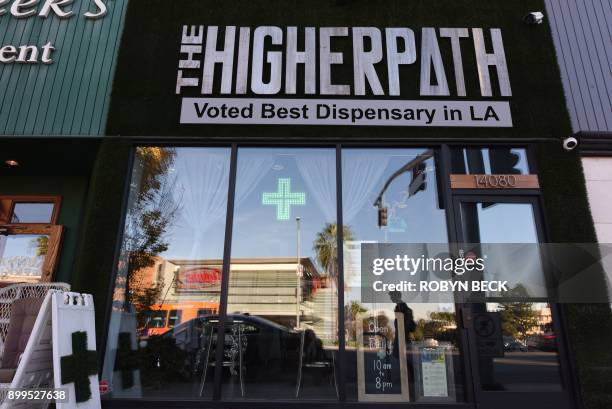 Man walks by the Higher Path medical marijuana dispensary in the Sherman Oaks area of Los Angeles, California, December 27, 2017. At the stroke of...