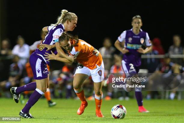 Kim Carroll of the Perth Glory and Abbey Lloyd of the Roar contest for the ball during the round nine W-League match between the Perth Glory and...