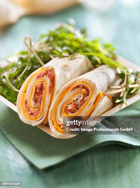 preserved tomato and edam wrap served with rocket lettuce - sushi wrap stock pictures, royalty-free photos & images