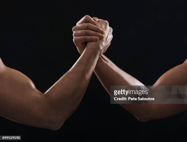 arms of muscular women gripping hands - arm wrestle stock pictures, royalty-free photos & images