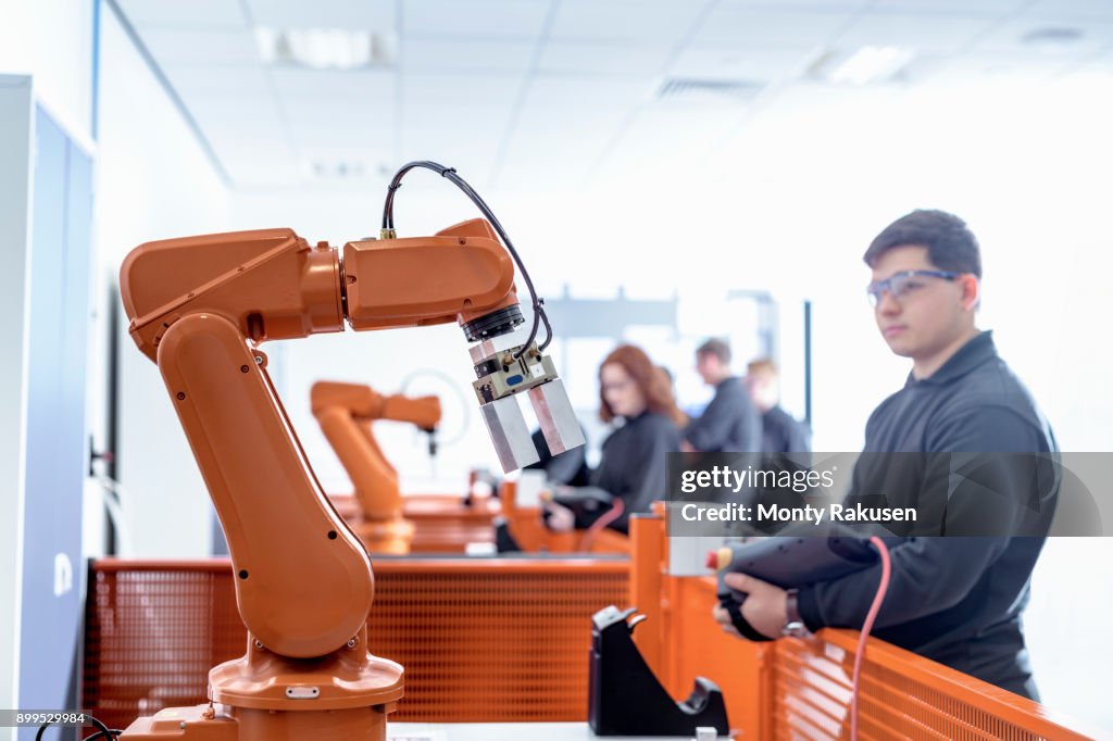 Robotics Apprentice With Robot In Robotics Facility High-Res Stock ...