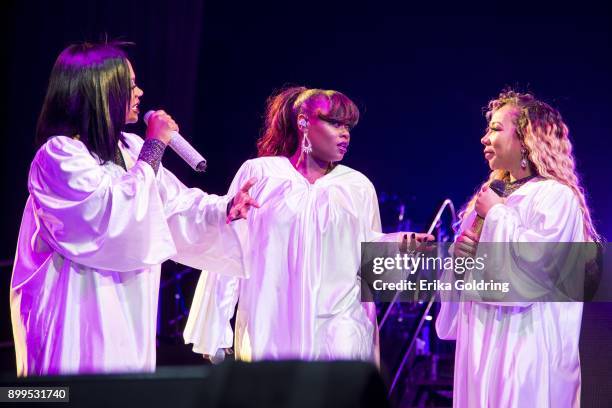 Kandi Burruss, Tamika Scott, and Tameka 'Tiny' Cottle of Xscape perform during The Great Xscape Tour at Smoothie King Center on December 28, 2017 in...