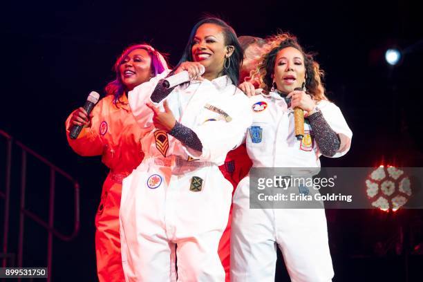 LaTocha Scott, Kandi Burruss and Tameka 'Tiny' Cottle of Xscape perform during The Great Xscape Tour at Smoothie King Center on December 28, 2017 in...