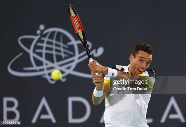 Roberto Bautista Agut of Spain plays a backhand during his exhibition match against Andy Murray of Great Britain on day two of the Mubadala World...