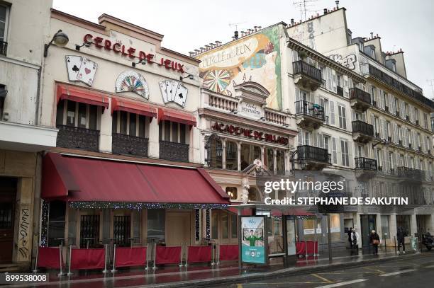 This picture taken on December 29, 2017 shows the facades of the 'Cercle de Jeux' and 'Academie de billard' gambling clubs in Paris. - From January...