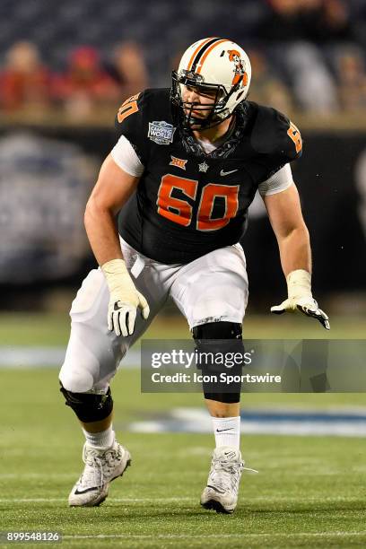 Oklahoma State Cowboys offensive lineman Zachary Crabtree drops back to pass protect during the second half of the Camping World Bowl game between...