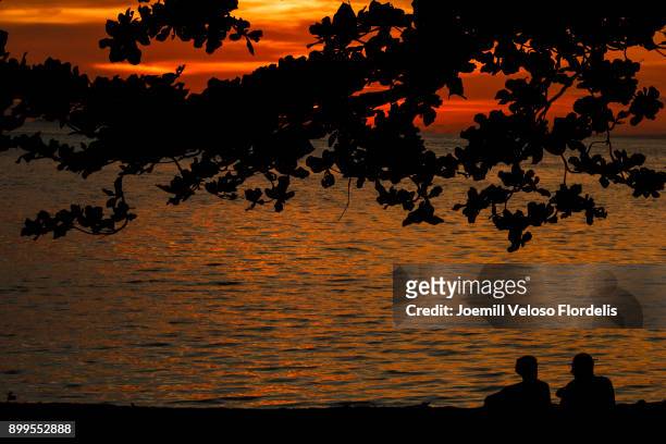 siquijor sunset (san juan, siquijor philippines) - joemill flordelis stock pictures, royalty-free photos & images