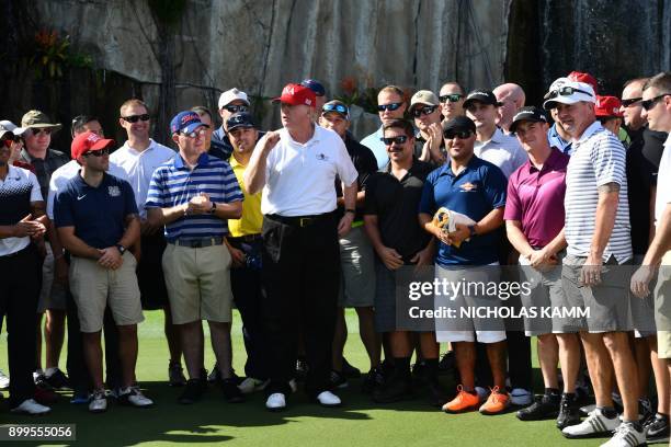 President Donald Trump speaks to service members of the United States Coast Guard during an invitation to play golf at Trump International Golf...