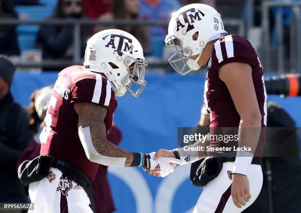 Trayveon Williams celebrates with teammate Nick Starkel of the Texas A&M Aggies after running for a touchdown against the Wake Forest Demon Deacons...