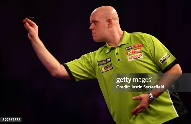 Michael Van Gerwen in action during his Quarter Final Match against Raymond Van Barneveld during the 2018 William Hill PDC World Darts Championships...