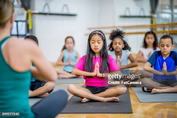 meditation with eyes closed - kids meditating stock pictures, royalty-free photos & images