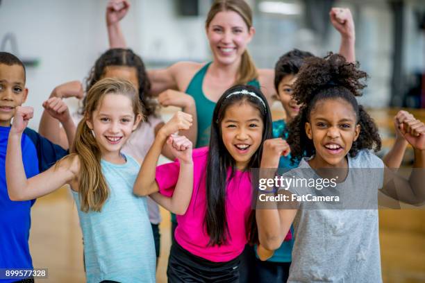 flexing for the camera - girl in gym stock pictures, royalty-free photos & images