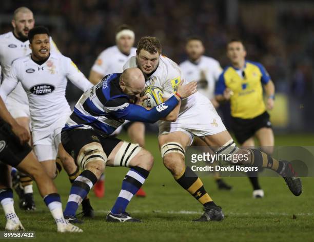 Joe Launchbury of Wasps is stopped by Matt Garvey during the Aviva Premiership match between Bath Rugby and Wasps at the Recreation Ground on...