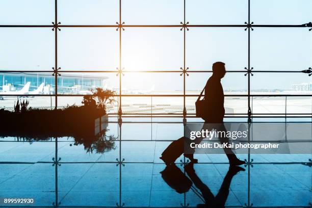 airport business people - business man walking with a bag in asia bildbanksfoton och bilder