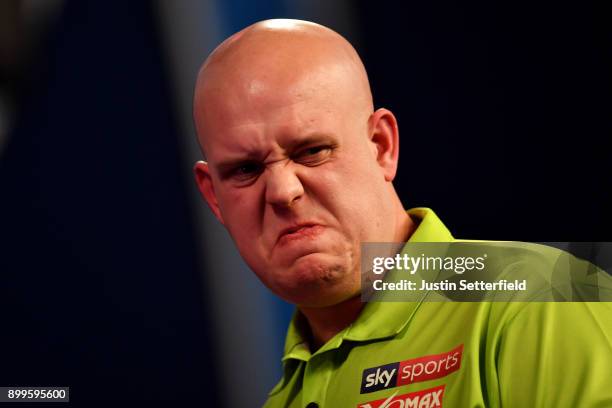 Michael Van Gerwen reacts during his Quarter Final Match against Raymond Van Barneveld during the 2018 William Hill PDC World Darts Championships on...
