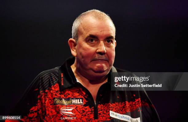 Phil Taylor reacts during his Quarter Final Match against Gary Anderson during the 2018 William Hill PDC World Darts Championships on Day Thirteen at...