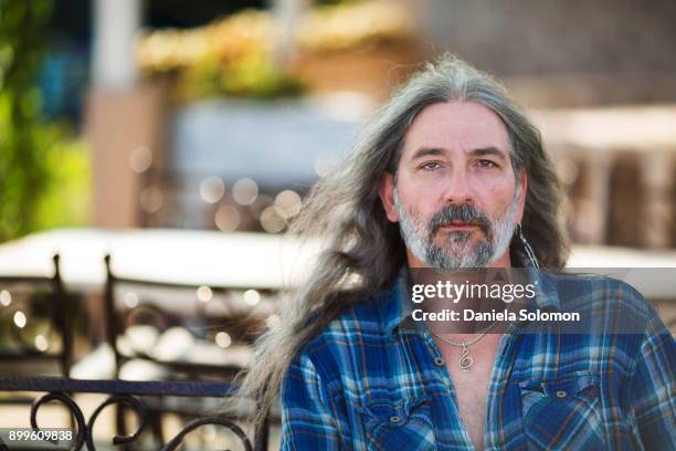 man with long hair and beard looking at camera - osteuropäischer abstammung stock-fotos und bilder