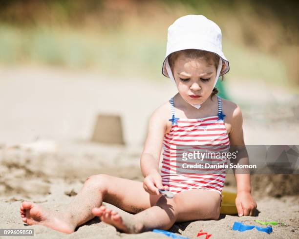 cute girl enjoying sand on the beach - 2 girls 1 sandbox stock pictures, royalty-free photos & images