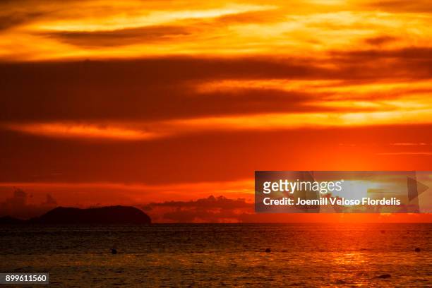 siquijor sunset (san juan, siquijor philippines) - joemill flordelis stock pictures, royalty-free photos & images