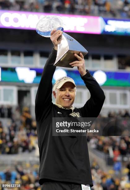 Head coach Dave Clawson of the Wake Forest Demon Deacons celebrates with the trophy after defeating the Texas A&M Aggies 55-52 after the Belk Bowl at...