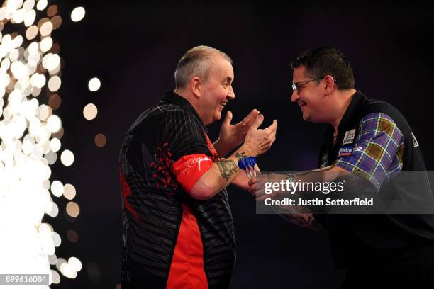 Phil Taylor celebrates after winning his Quarter Final Match against Gary Anderson during the 2018 William Hill PDC World Darts Championships on Day...