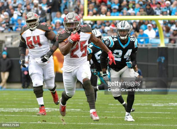 Peyton Barber of the Tampa Bay Buccaneers rus against the Carolina Panthers during their game at Bank of America Stadium on December 24, 2017 in...