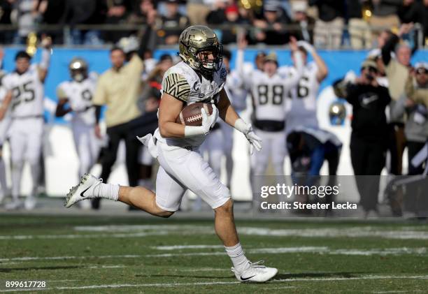 Cam Serigne of the Wake Forest Demon Deacons catches a touchdown against the Texas A&M Aggies during the Belk Bowl at Bank of America Stadium on...