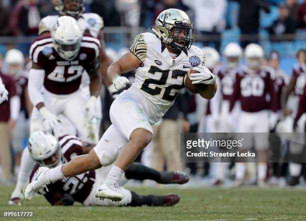 Matt Colburn of the Wake Forest Demon Deacons runs with the ball against the Texas A&M Aggies during the Belk Bowl at Bank of America Stadium on...