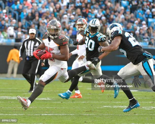 Peyton Barber of the Tampa Bay Buccaneers runs against the Carolina Panthers during their game at Bank of America Stadium on December 24, 2017 in...
