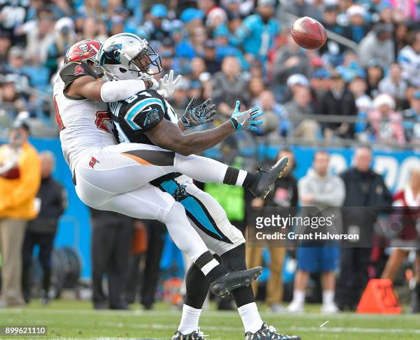 Vernon Hargreaves of the Tampa Bay Buccaneers tackles Ed Dickson of the Carolina Panthers during their game at Bank of America Stadium on December...