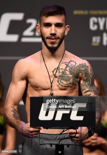 Matheus Nicolau of Brazil poses on the scale during the UFC 219 weigh-in inside T-Mobile Arena on December 29, 2017 in Las Vegas, Nevada.