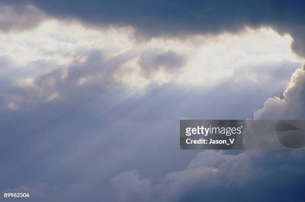 clouds breaking w/ beams - touched by an angel stockfoto's en -beelden