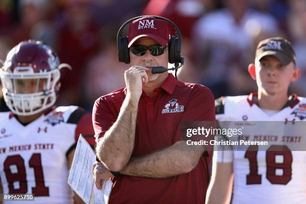 Head Coach Doug Martin of the New Mexico State Aggies looks on during the first half of the Nova Home Loans Arizona Bowl game against the Utah State...