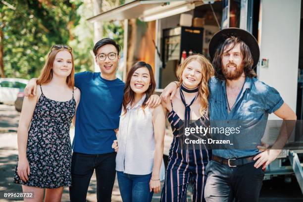 group of multi ethnic people posing near the food truck after delicious meal - youth culture australia stock pictures, royalty-free photos & images