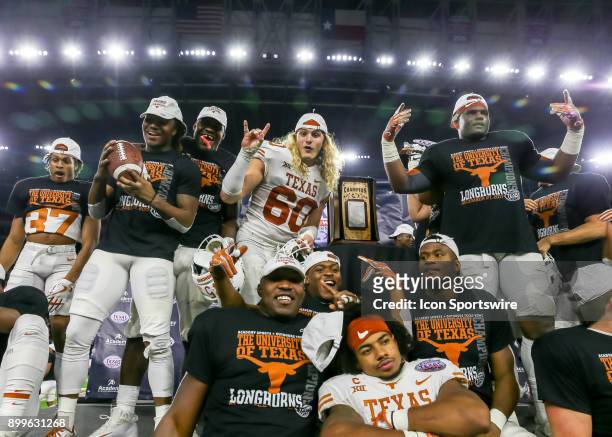 Texas Longhorns players celebrate after wining the Texas Bowl game between the Texas Longhorns and Missouri Tigers on December 27, 2017 at NRG...