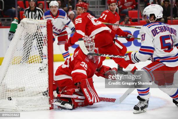David Desharnais of the New York Rangers scores a first period goal past Jimmy Howard of the Detroit Red Wings at Little Caesars Arena on December...