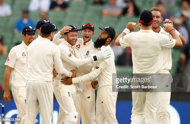 Jonny Bairstow and Stuart Broad of England celebrate after dismissing Shaun Marsh of Australia with Joe Root and their teammates during day one of...
