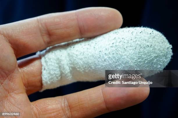 close up of a finger with a bandage - bruised finger stock-fotos und bilder