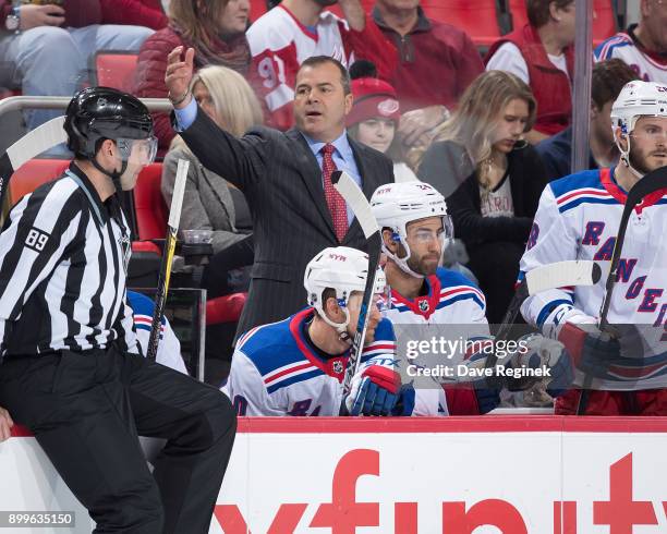 Head coach Alain Vigneault of the New York Rangers watches the play from the bench during an NHL game against the Detroit Red Wings at Little Caesars...