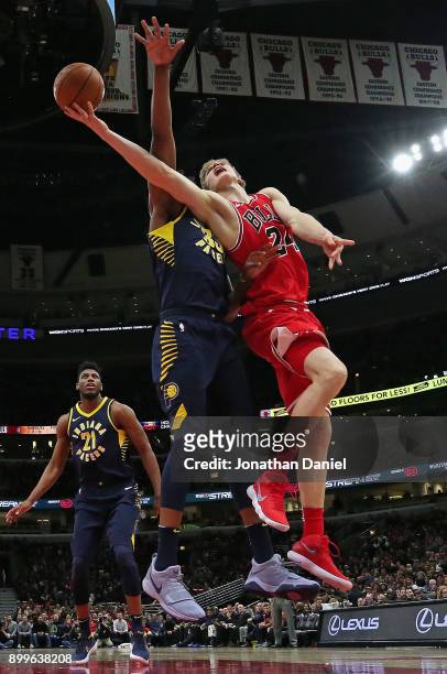 Lauri Markkanen of the Chicago Bulls puts up a shot against Myles Turner of the Indiana Pacers at the United Center on December 29, 2017 in Chicago,...