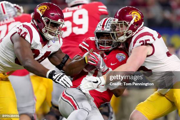 Barrett of the Ohio State Buckeyes carries the ball against Rasheem Green of the USC Trojans and Cameron Smith of the USC Trojans in the first...