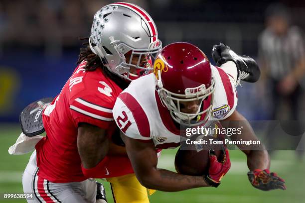 Tyler Vaughns of the USC Trojans pulls in a pass against Damon Arnette of the Ohio State Buckeyes in the first quarter during the Goodyear Cotton...