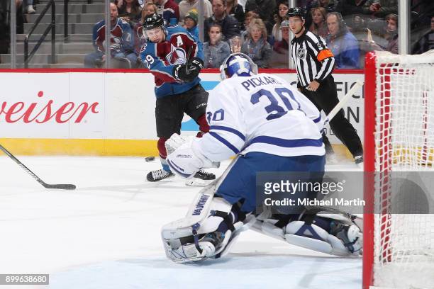 Nathan MacKinnon of the Colorado Avalanche scores against goaltender Calvin Pickard of the Toronto Maple Leafs at the Pepsi Center on December 29,...